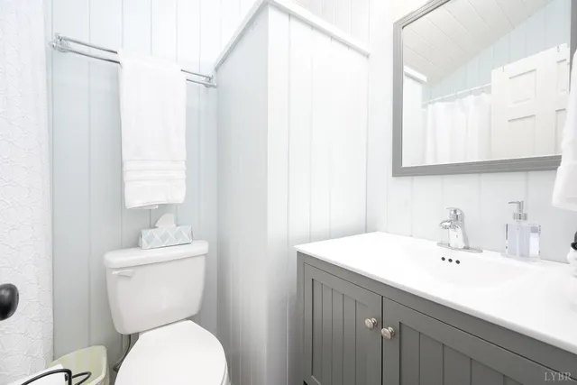 a view of a backyard with plants and brick wall