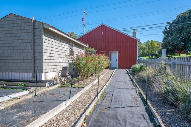 an aerial view of a house a yard and a garden