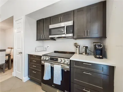 a kitchen with stainless steel appliances granite countertop a stove and a microwave