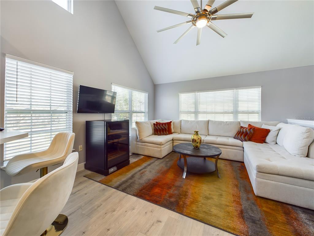 5521 Rosehill Road, Unit 203 Sarasota, FL 34233 - Photo 12 of 51 a living room with furniture a flat screen tv and a large window
