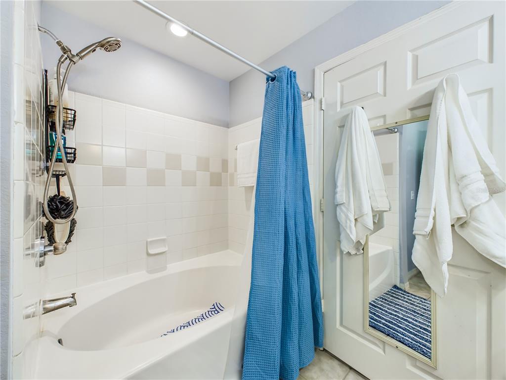 5521 Rosehill Road, Unit 203 Sarasota, FL 34233 - Photo 19 of 51 a bathroom with a bathtub and a shower