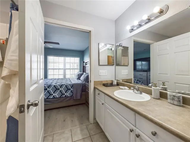 a spacious bedroom with a bed and a window