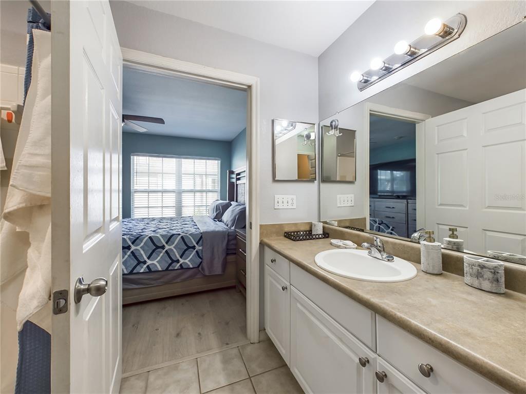 5521 Rosehill Road, Unit 203 Sarasota, FL 34233 - Photo 21 of 51 a spacious bedroom with a bed and a window