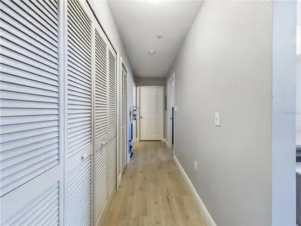 a view of a hallway with wooden floor