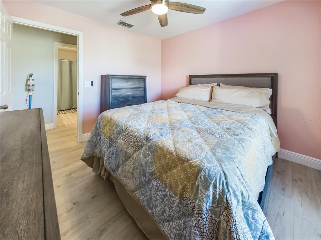 5521 Rosehill Road, Unit 203 Sarasota, FL 34233 - Photo 23 of 51 a bedroom with a bed and a ceiling fan