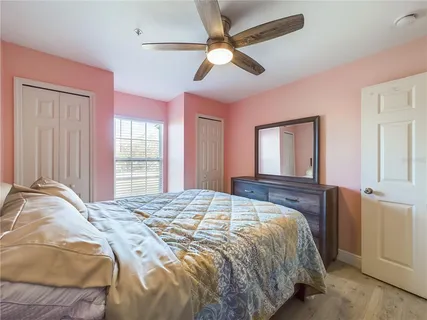 a bedroom with a large bed and a window