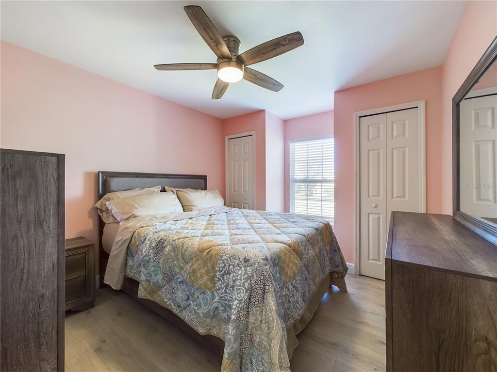 5521 Rosehill Road, Unit 203 Sarasota, FL 34233 - Photo 26 of 51 a bed sitting in a spacious bedroom next to a window