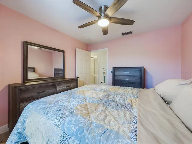 a bedroom with a bed and a dresser