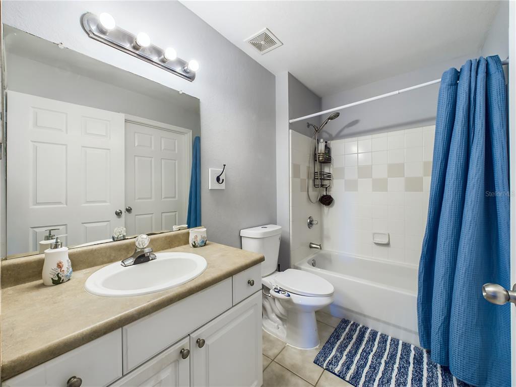 5521 Rosehill Road, Unit 203 Sarasota, FL 34233 - Photo 28 of 51 a bathroom with a sink a toilet a mirror and shower