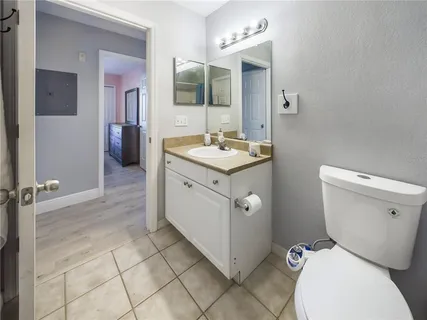 a spacious bathroom with a toilet sink and mirror