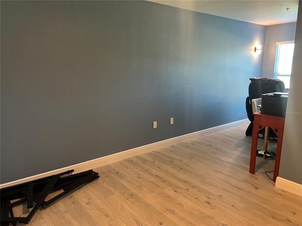 5521 Rosehill Road, Unit 203 Sarasota, FL 34233 - Photo 30 of 51 a view of a room with wooden floor and gym equipment