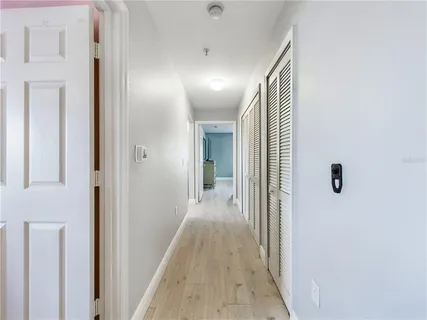 a view of hallway with wooden floor