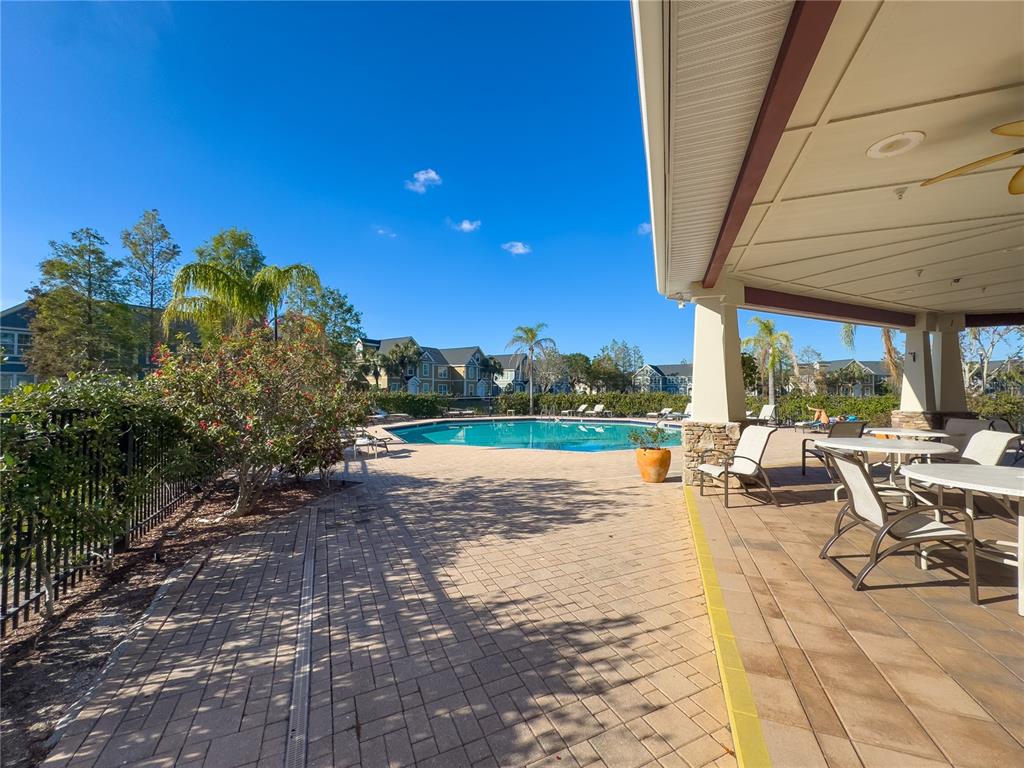 5521 Rosehill Road, Unit 203 Sarasota, FL 34233 - Photo 40 of 51 a view of a patio with a table and chairs under an umbrella
