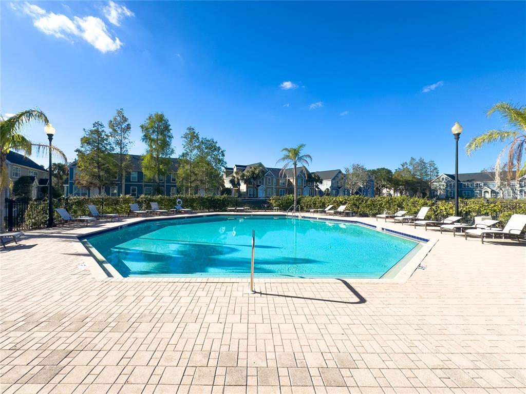 5521 Rosehill Road, Unit 203 Sarasota, FL 34233 - Photo 44 of 51 a view of a swimming pool with an outdoor space and seating area