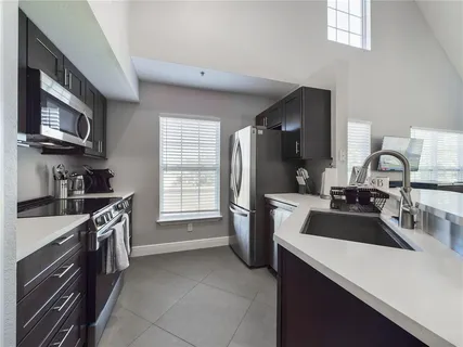 a kitchen with a sink stove and refrigerator