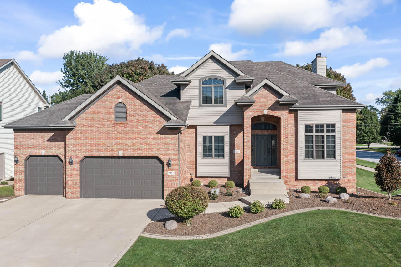 a front view of a house with a garden and plants