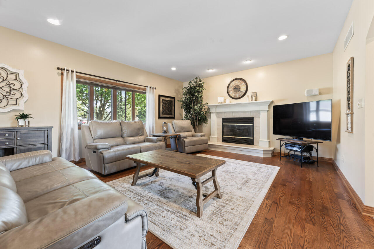 205 North Elgin Street Griffith, IN 46319 - Photo 12 of 43 a living room with furniture a flat screen tv and a fireplace
