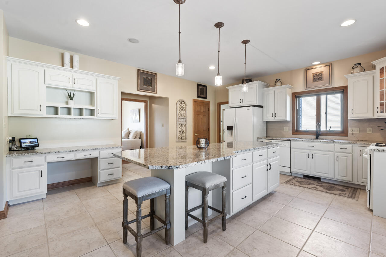 205 North Elgin Street Griffith, IN 46319 - Photo 19 of 43 a large kitchen with white cabinets and stainless steel appliances