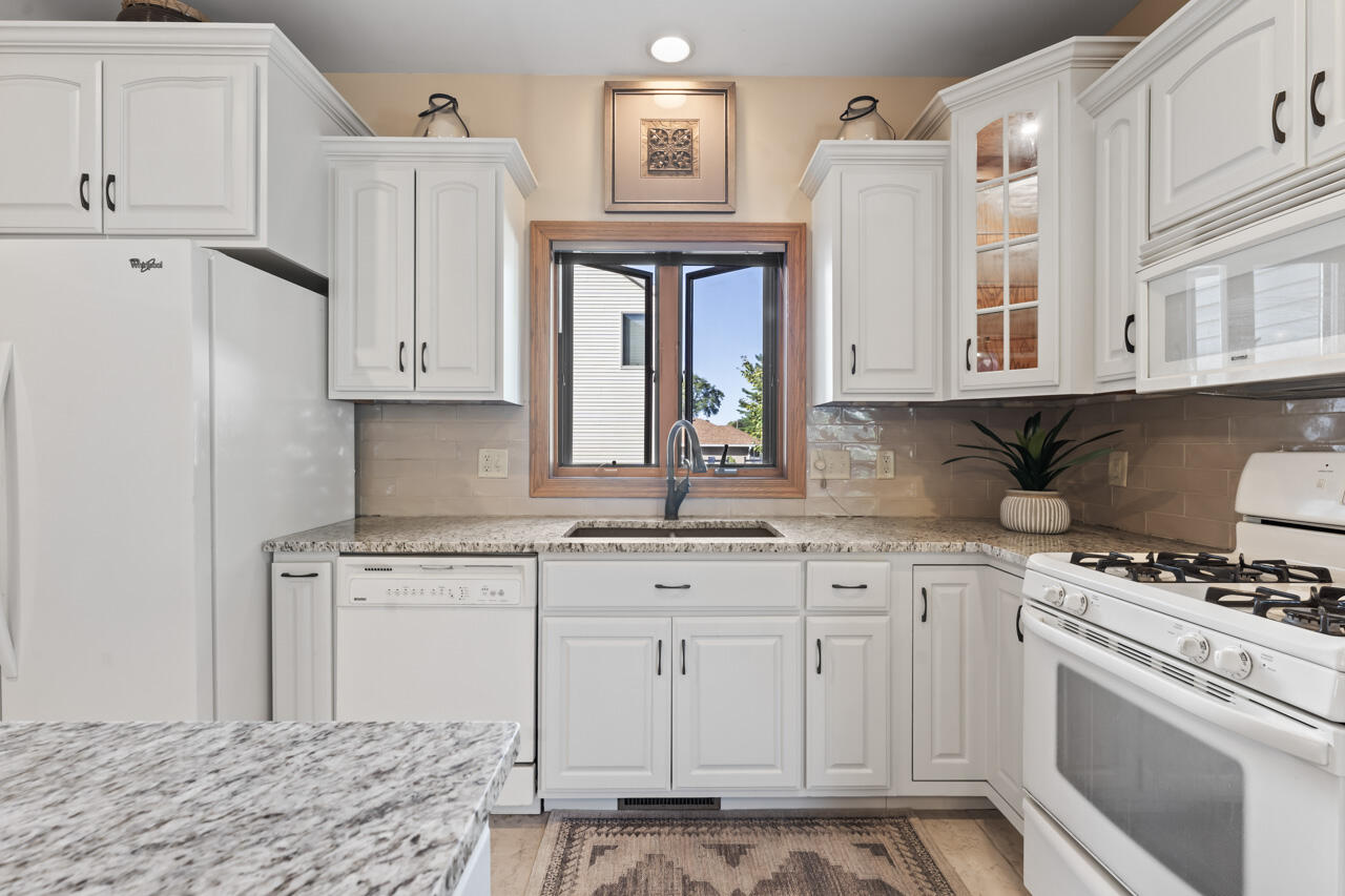 205 North Elgin Street Griffith, IN 46319 - Photo 20 of 43 a kitchen with stainless steel appliances granite countertop a stove a sink and a refrigerator