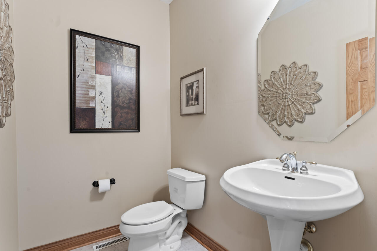 205 North Elgin Street Griffith, IN 46319 - Photo 22 of 43 a bathroom with a sink mirror and toilet