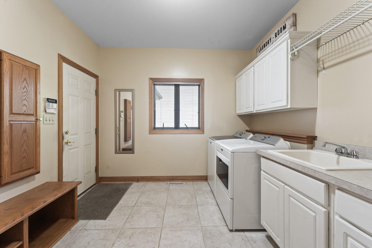 205 North Elgin Street Griffith, IN 46319 - Photo 23 of 43 a utility room with cabinets washer and dryer