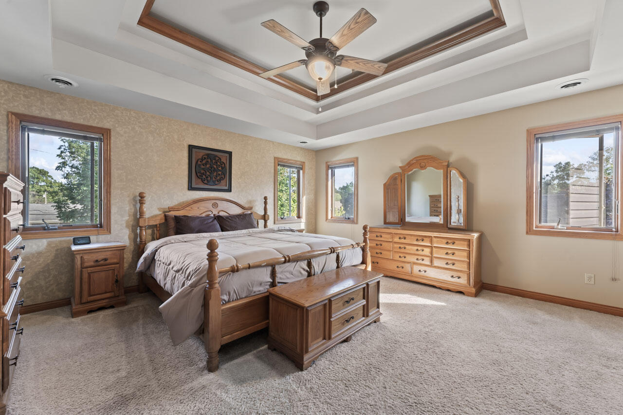 205 North Elgin Street Griffith, IN 46319 - Photo 24 of 43 a bedroom with a bed next to a window and a chandelier