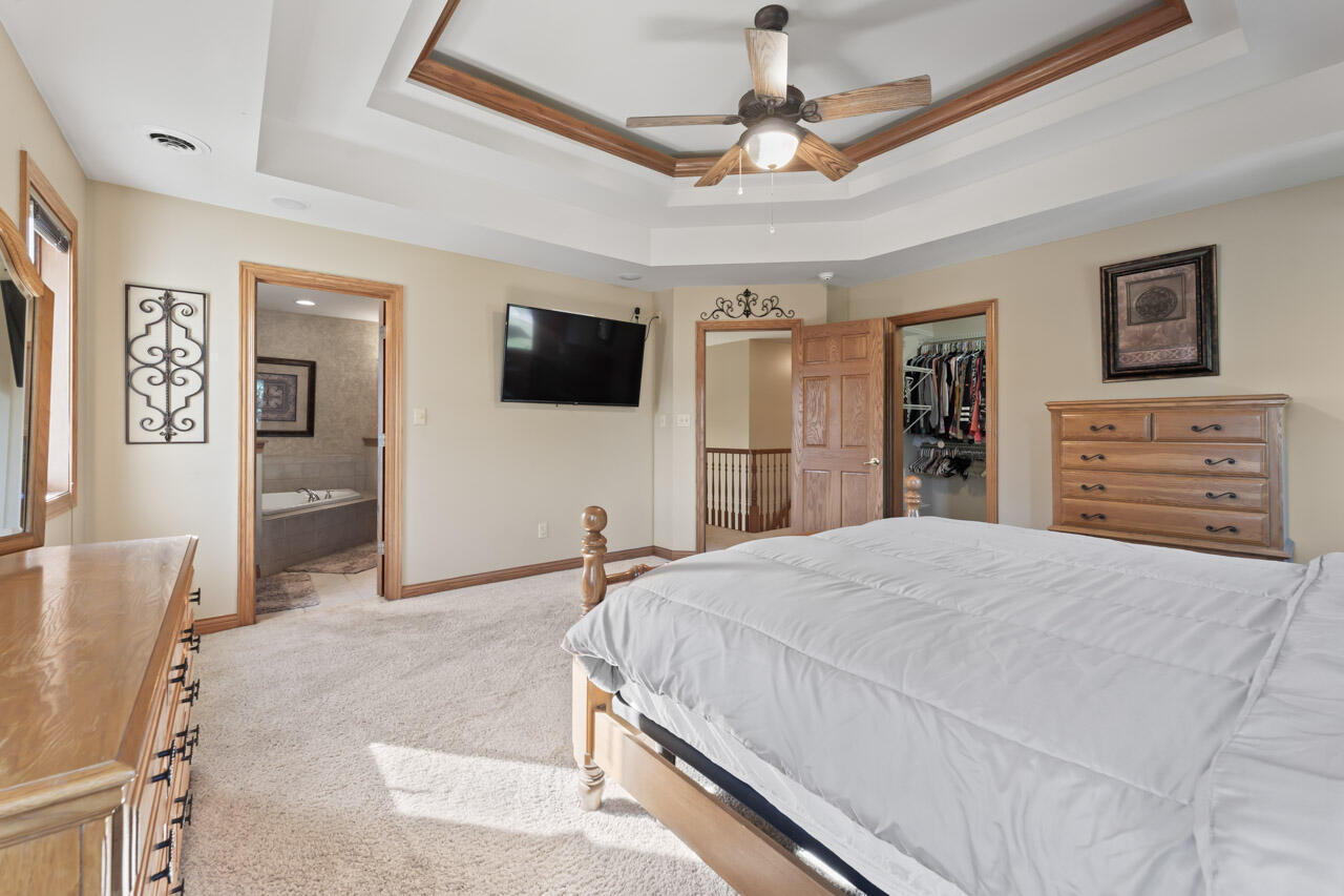 205 North Elgin Street Griffith, IN 46319 - Photo 25 of 43 a bedroom with a bed and a flat screen tv