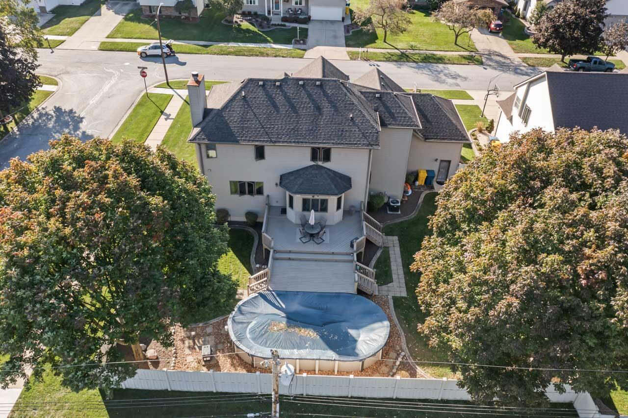 205 North Elgin Street Griffith, IN 46319 - Photo 41 of 43 a swimming pool with barbeque oven outdoor seating and yard