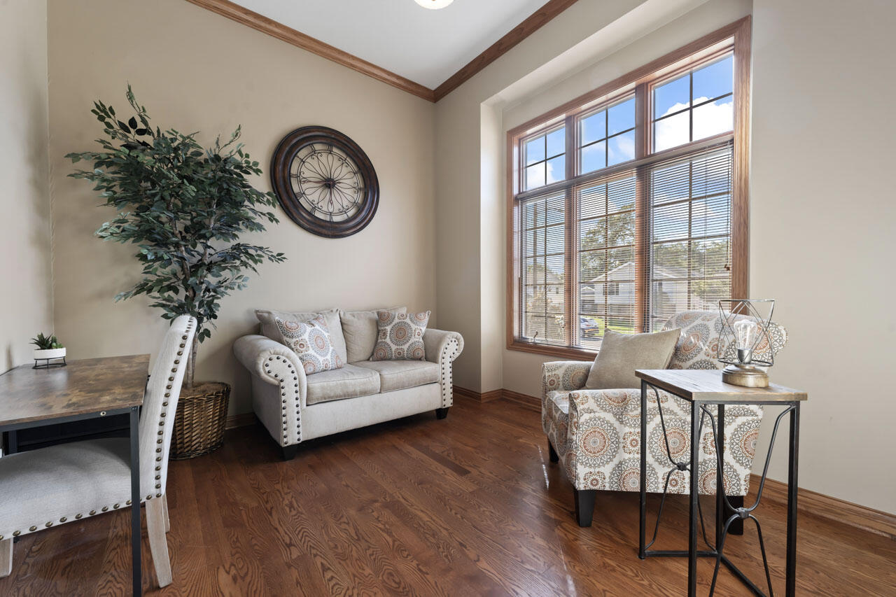 205 North Elgin Street Griffith, IN 46319 - Photo 7 of 43 a living room with furniture a clock and a large window