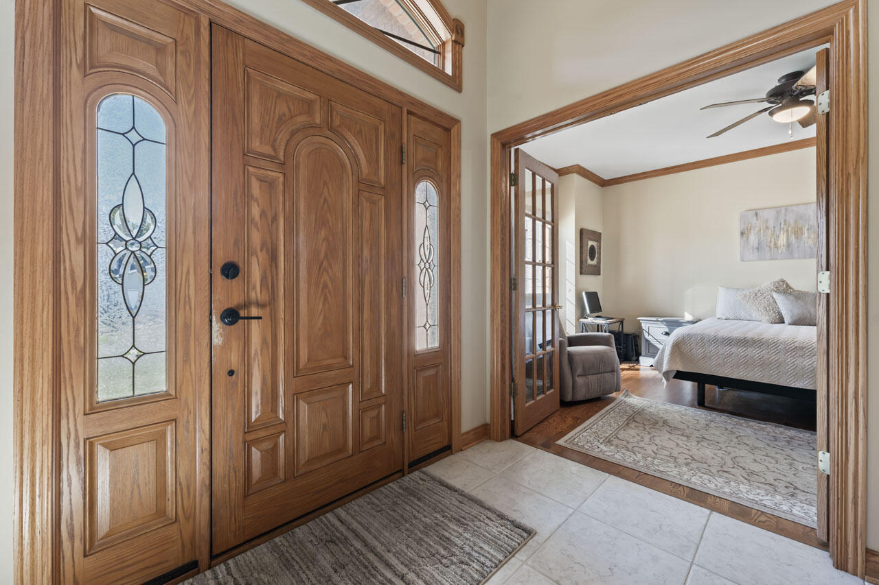 205 North Elgin Street Griffith, IN 46319 - Photo 9 of 43 a bedroom with a bed and a mirror