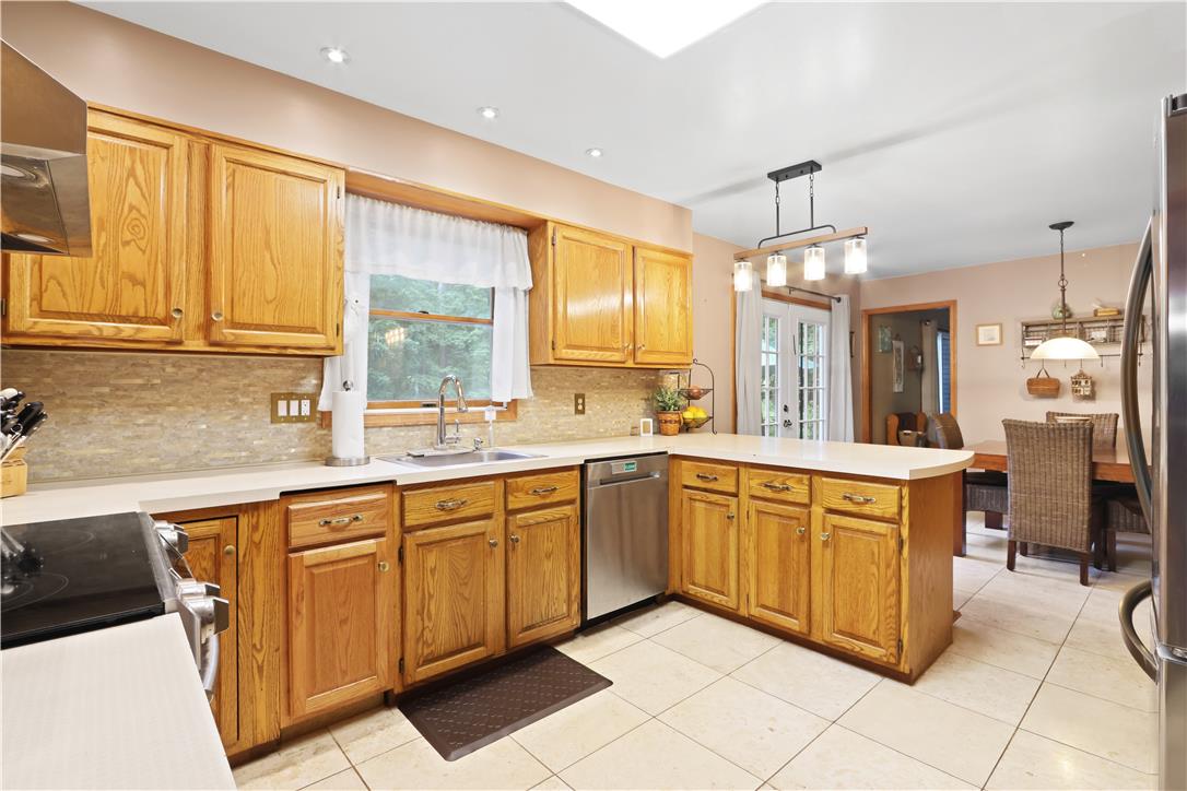 209 Remington Road East Stroudsburg, PA 18301 - Photo 14 of 41 A well-appointed kitchen features warm wooden cabinetry, a practical layout, and a convenient breakfast bar.