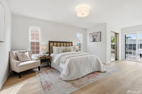 a spacious bedroom with a bed and a couch