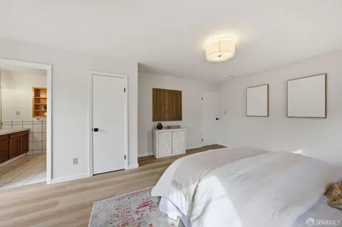 a bedroom with a bed and a tv on table