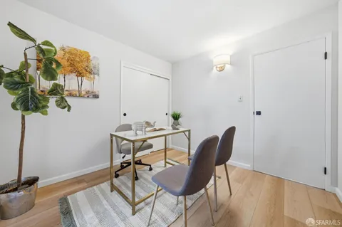 a view of a workspace with furniture and a potted plant