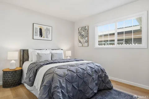 a bed sitting in a bedroom next to a window