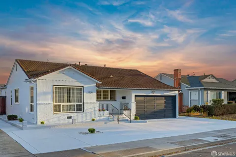 a front view of a house with yard and seating space