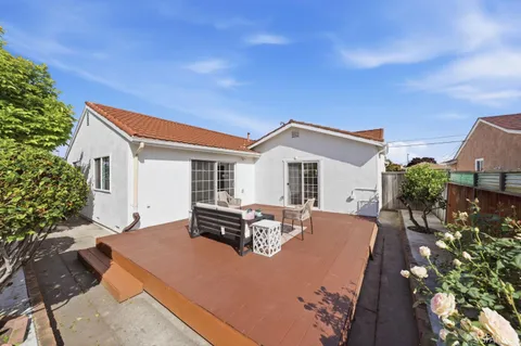 a view of house with swimming pool outdoor seating