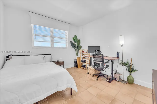 a bedroom with a bed a table and chair