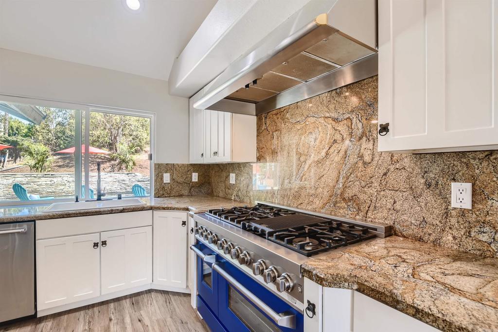 808 Hitching Post Road Vista, CA 92081 - Photo 11 of 29 a kitchen with white cabinets and appliances