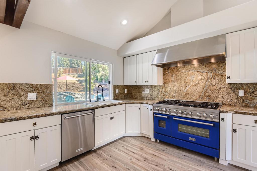808 Hitching Post Road Vista, CA 92081 - Photo 12 of 29 a kitchen with stainless steel appliances granite countertop a stove and a sink