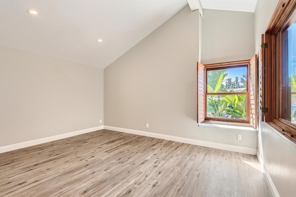 808 Hitching Post Road Vista, CA 92081 - Photo 16 of 29 an empty room with wooden floor and windows