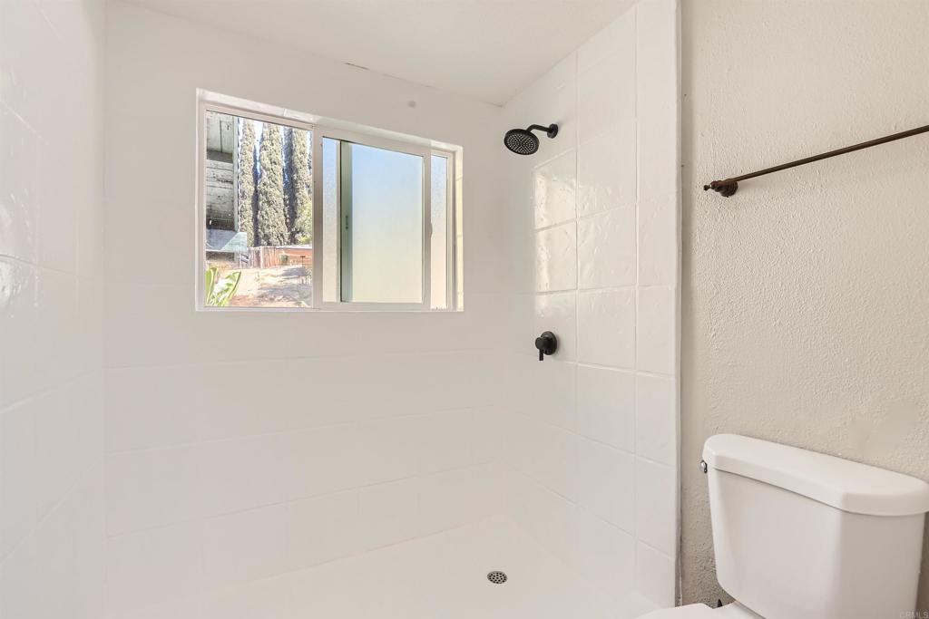 808 Hitching Post Road Vista, CA 92081 - Photo 19 of 29 a bathroom with a shower and a toilet