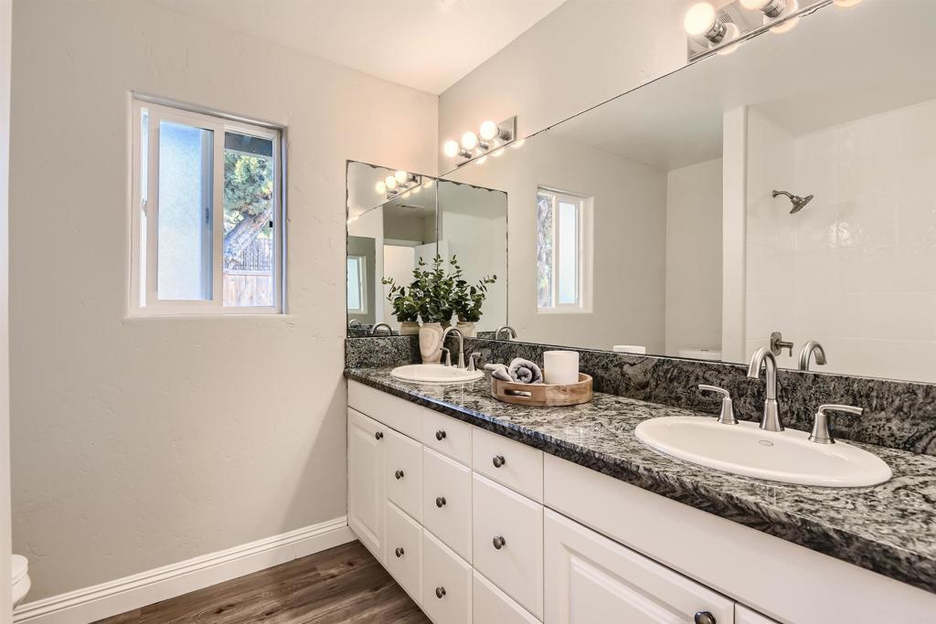 808 Hitching Post Road Vista, CA 92081 - Photo 21 of 29 a bathroom with a granite countertop sink mirror and a