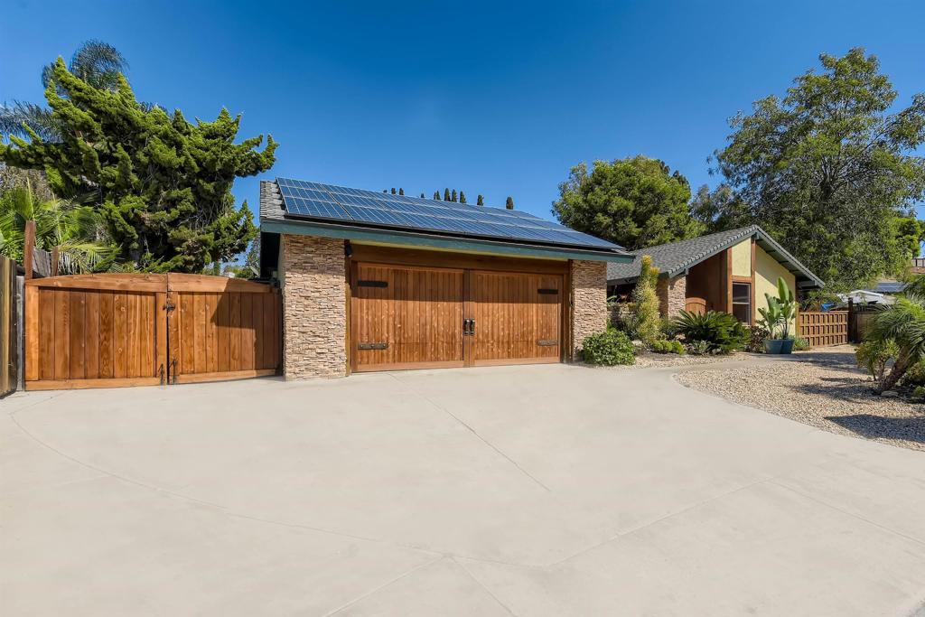 808 Hitching Post Road Vista, CA 92081 - Photo 3 of 29 a front view of a house with a yard and garage
