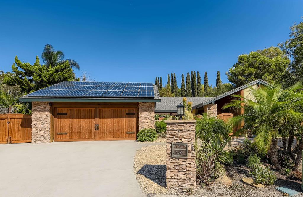 808 Hitching Post Road Vista, CA 92081 - Photo 4 of 29 a front view of a house with a yard and garage