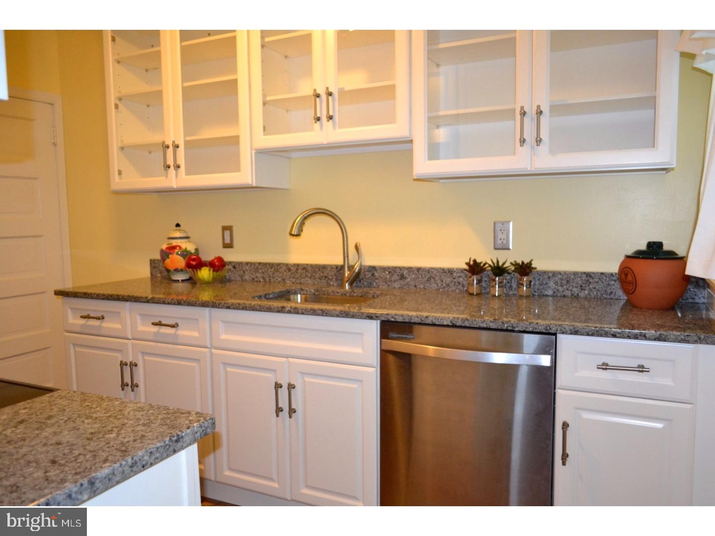 129 Walsh Road Lansdowne, PA 19050 - Photo 1 of 25 a kitchen with stainless steel appliances granite countertop a sink dishwasher and cabinets with wooden floor