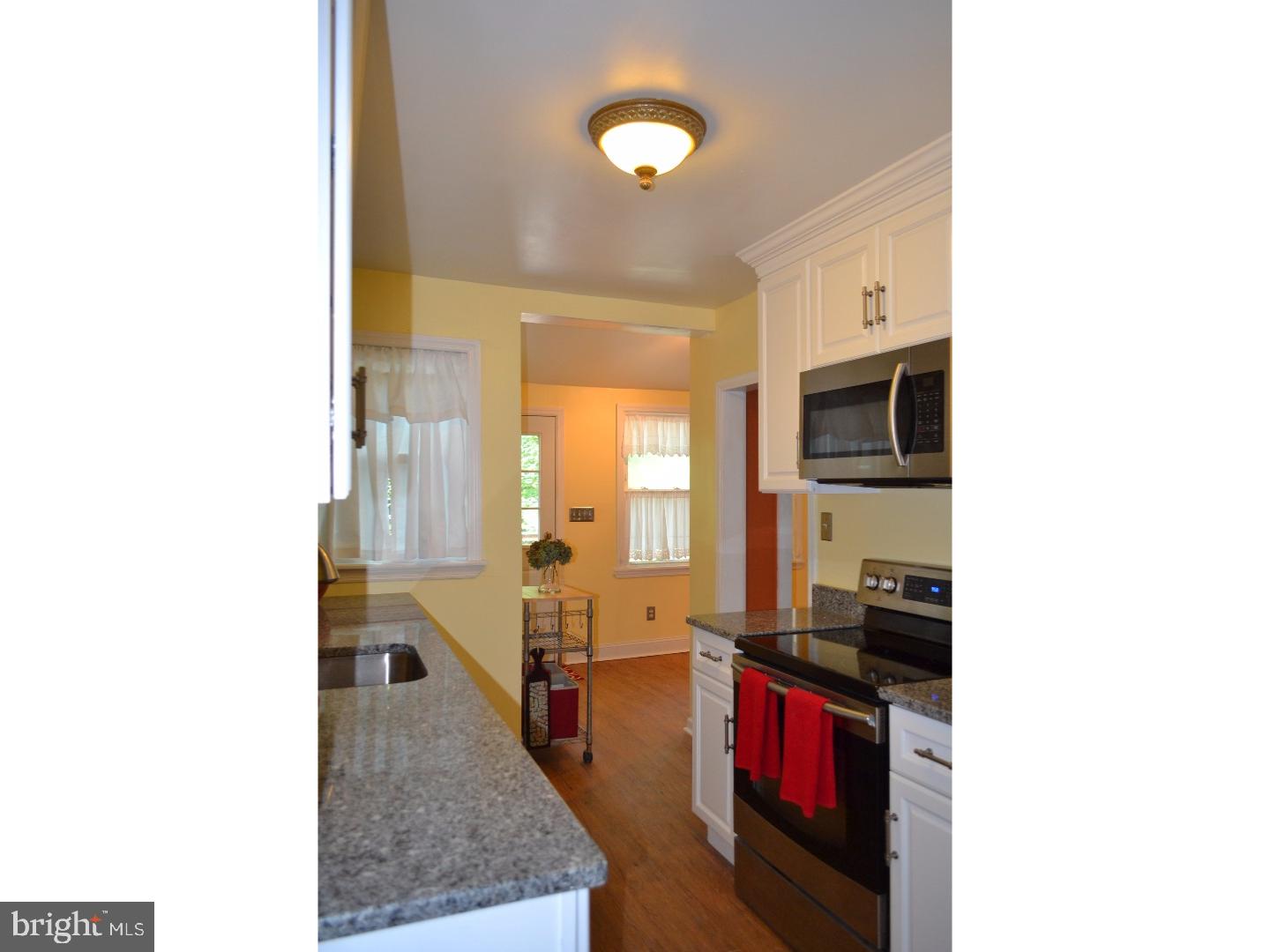129 Walsh Road Lansdowne, PA 19050 - Photo 11 of 25 a living room with stainless steel appliances kitchen island granite countertop a refrigerator and a stove top oven