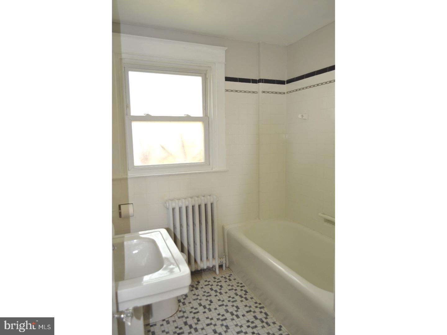 129 Walsh Road Lansdowne, PA 19050 - Photo 16 of 25 a bathroom with a bathtub and a shower