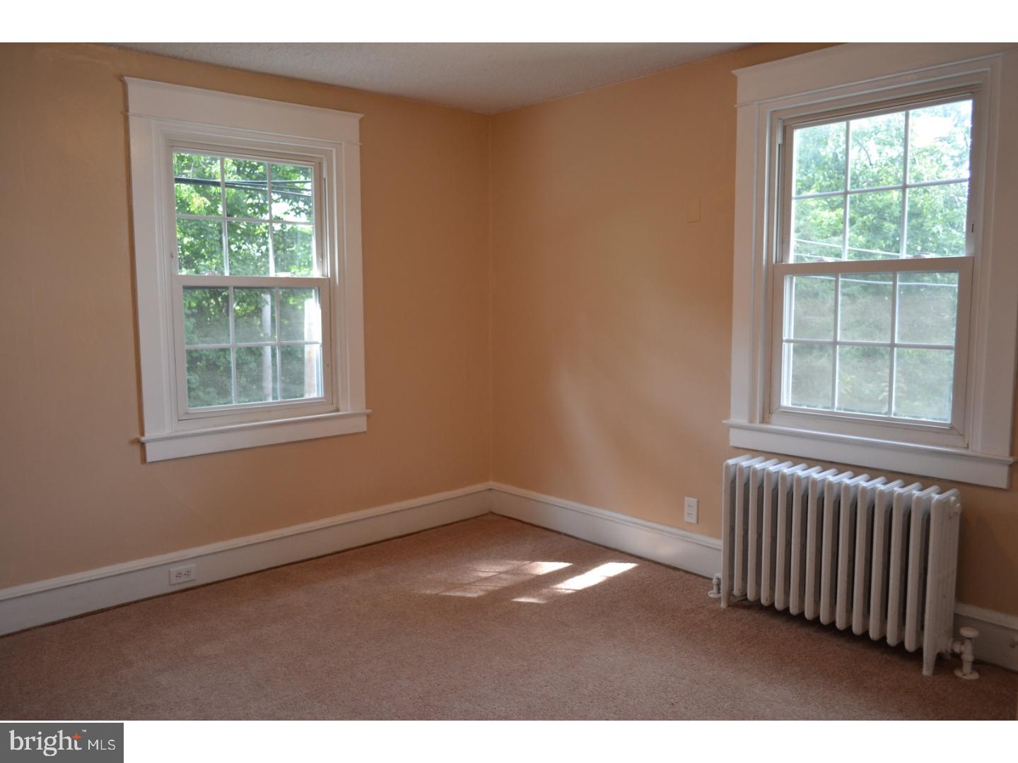 129 Walsh Road Lansdowne, PA 19050 - Photo 17 of 25 an empty room with wooden floor and windows