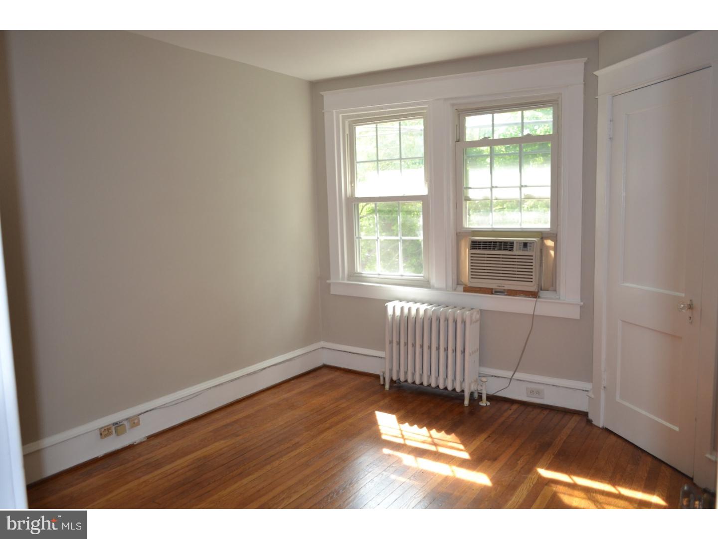 129 Walsh Road Lansdowne, PA 19050 - Photo 18 of 25 an empty room with wooden floor and windows